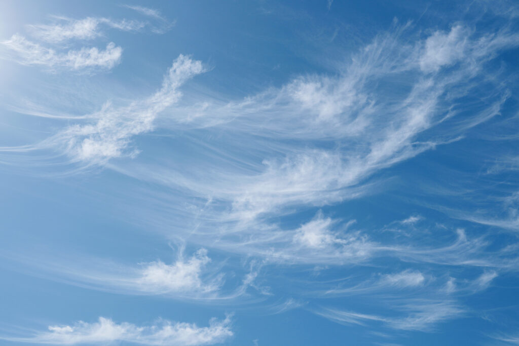 Beautiful wispy cirrus clouds in blue sky on freedom, energize a